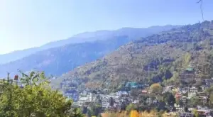 A picturesque view of Manali town with snow-covered mountains.