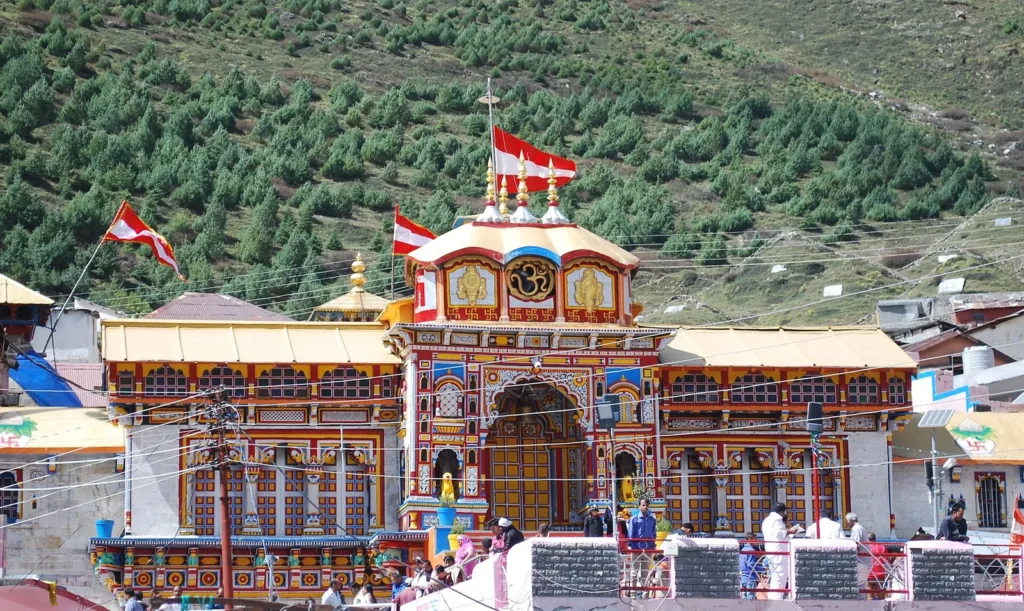 Colourful painted facade of Badrinath temple with pilgrims in front