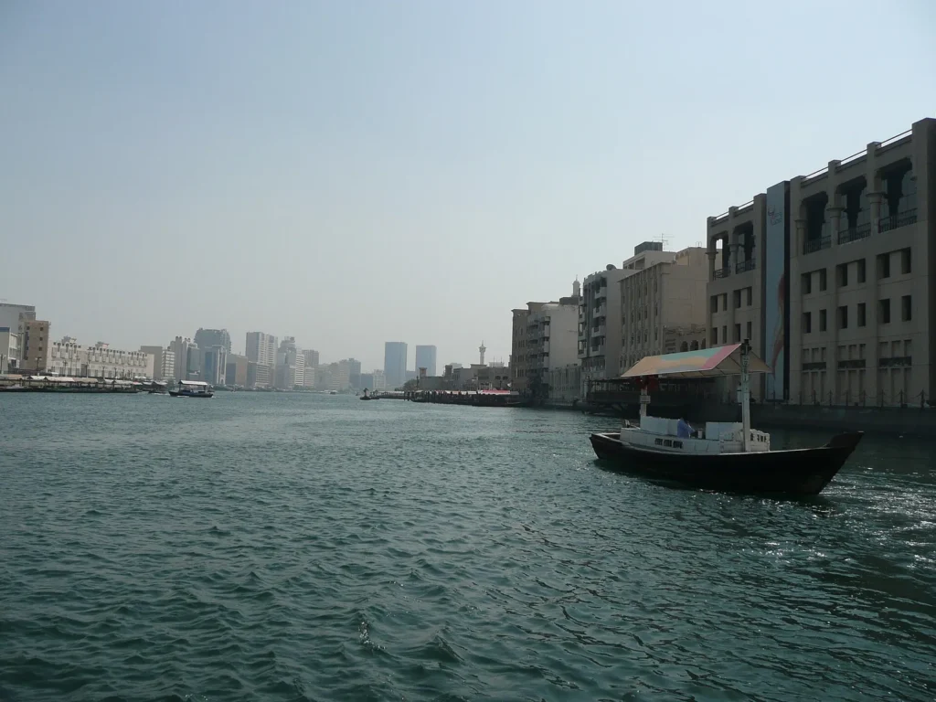 View across Dubai Creek with low buildings on the far bank