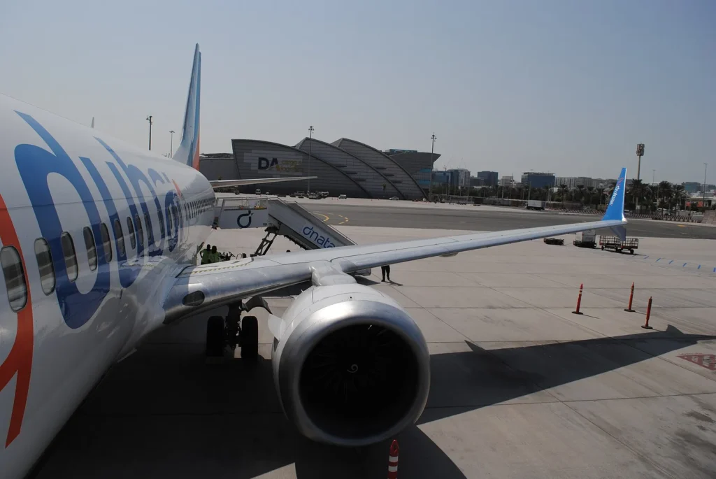 An Emirates aircraft parked at a gate at Dubai International Airport