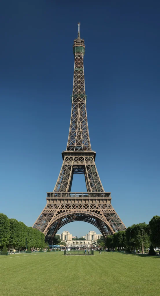 The Eiffel Tower rising above trees and the lawns of the Champ de Mars