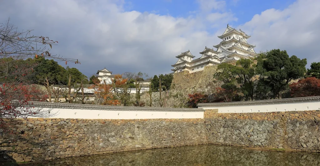 The white keep of Himeji Castle on its hill under a blue sky