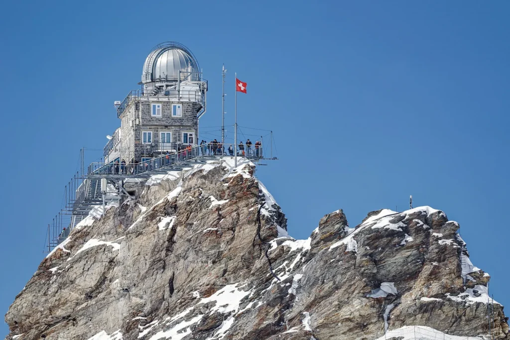 The Sphinx Observatory on a rocky snow covered ridge at the Jungfraujoch