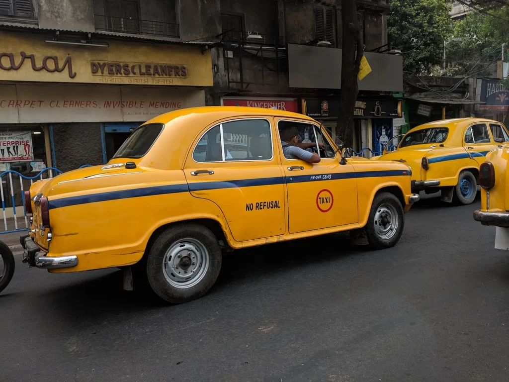 A yellow Ambassador taxi on a Kolkata street