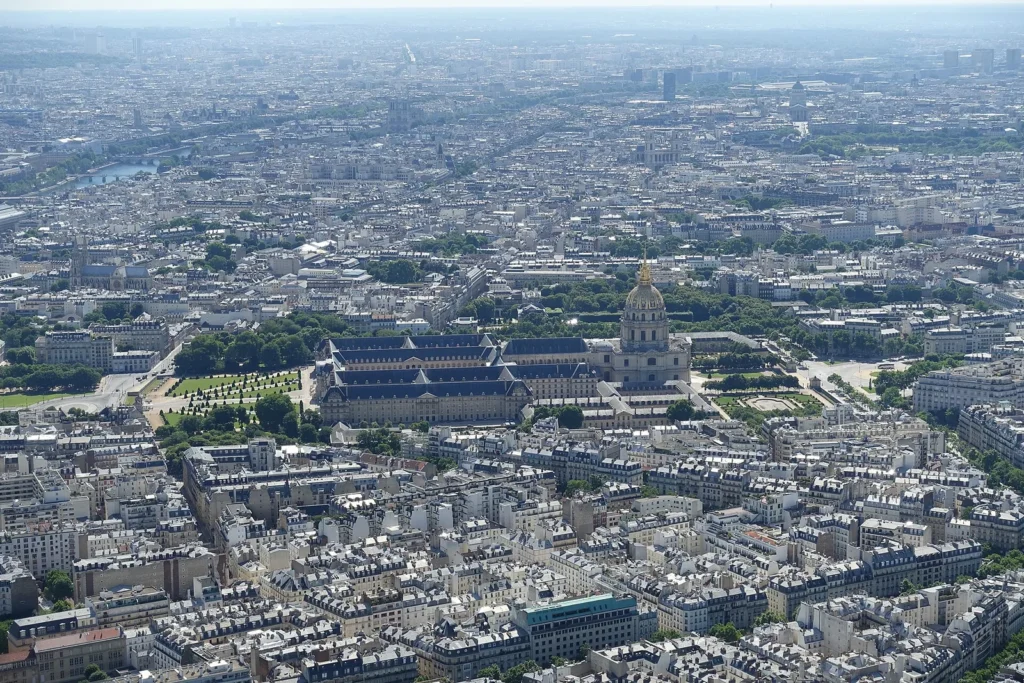 Les Invalides and its gold dome among Paris rooftops seen from the Eiffel Tower summit