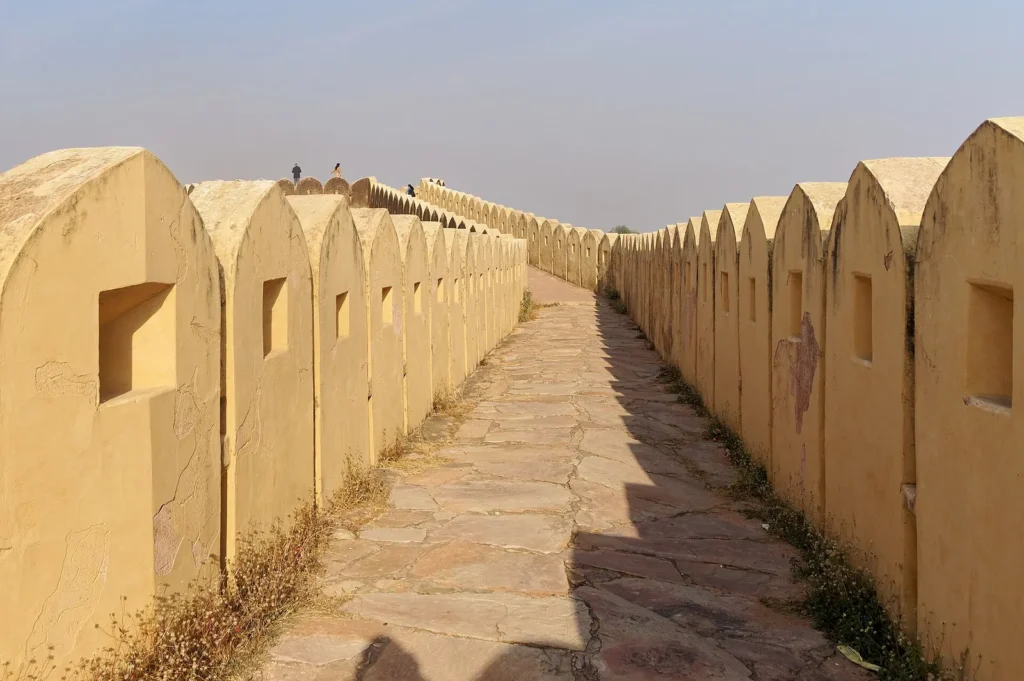 Stone walkway between the crenellated fortification walls of Nahargarh Fort