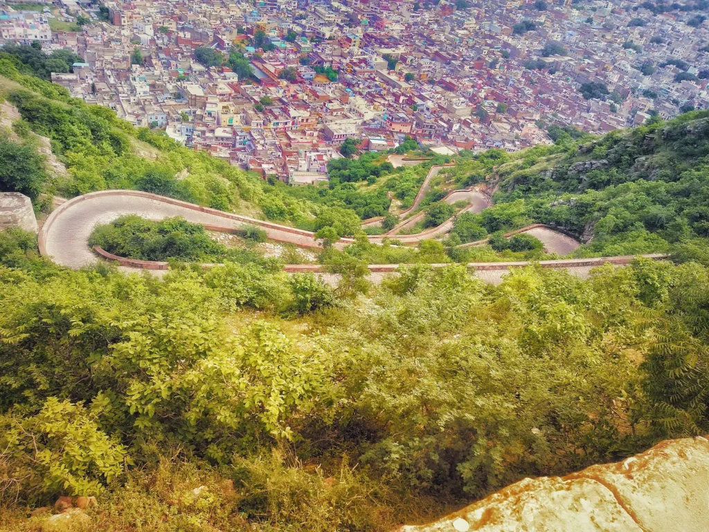 Hairpin bends of the hill road climbing to Nahargarh Fort with Jaipur city behind