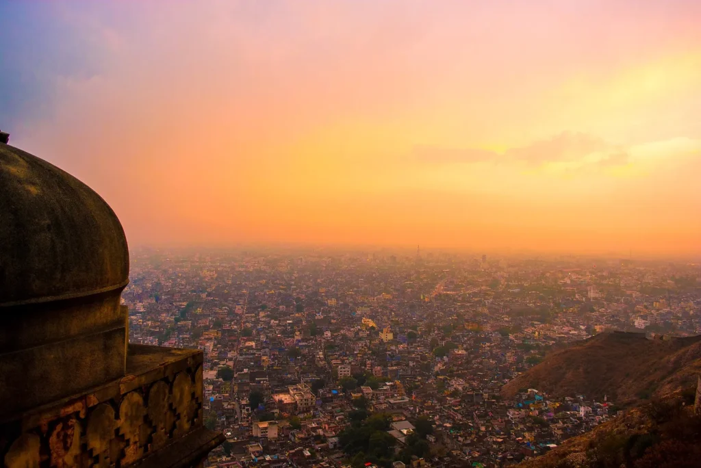 Orange sunset sky over Jaipur city seen from a dome on the ramparts of Nahargarh Fort