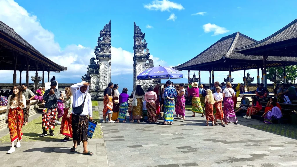 Visitors in sarongs gathered in front of the split gate at Pura Lempuyang in east Bali