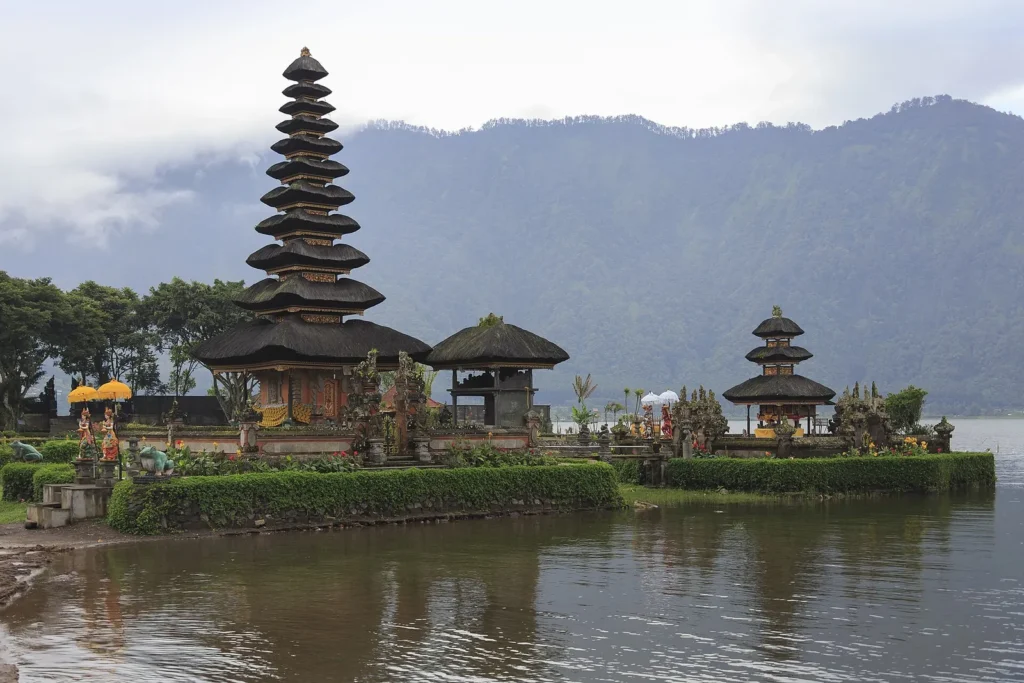 Tiered meru shrines of Pura Ulun Danu Bratan on the edge of Lake Bratan in Bali with hills behind