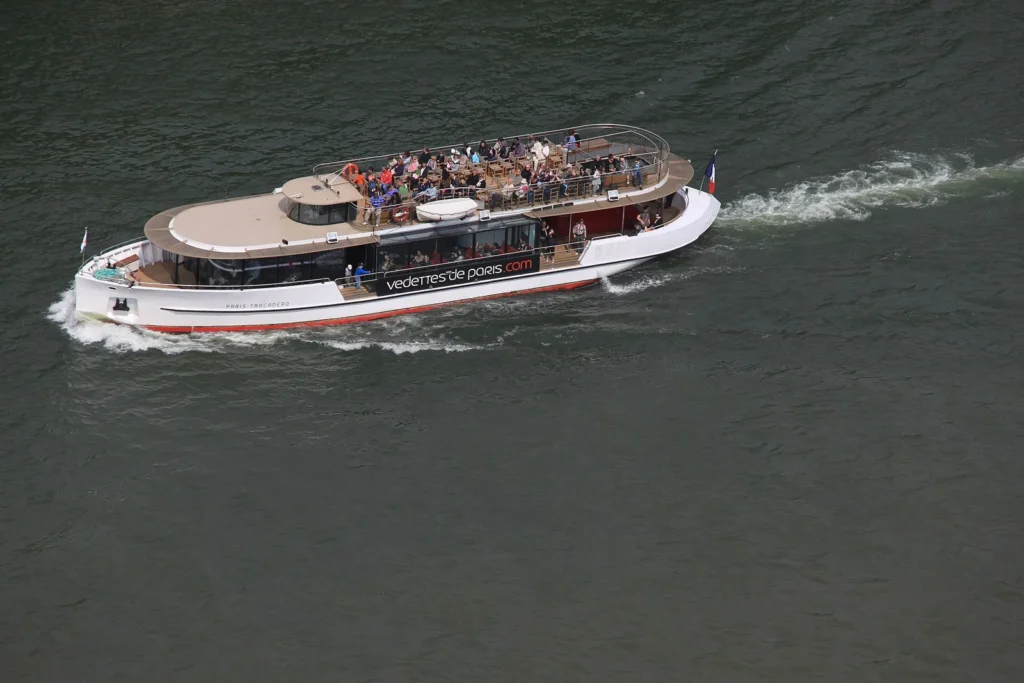 A tour boat on the Seine seen from above on the Eiffel Tower