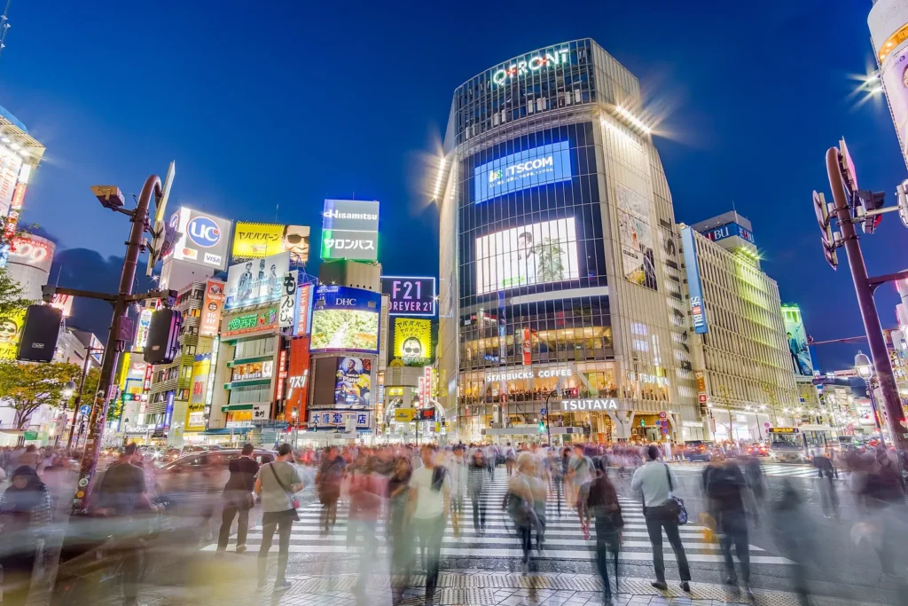 Crowds of people crossing the Shibuya scramble crossing in Tokyo