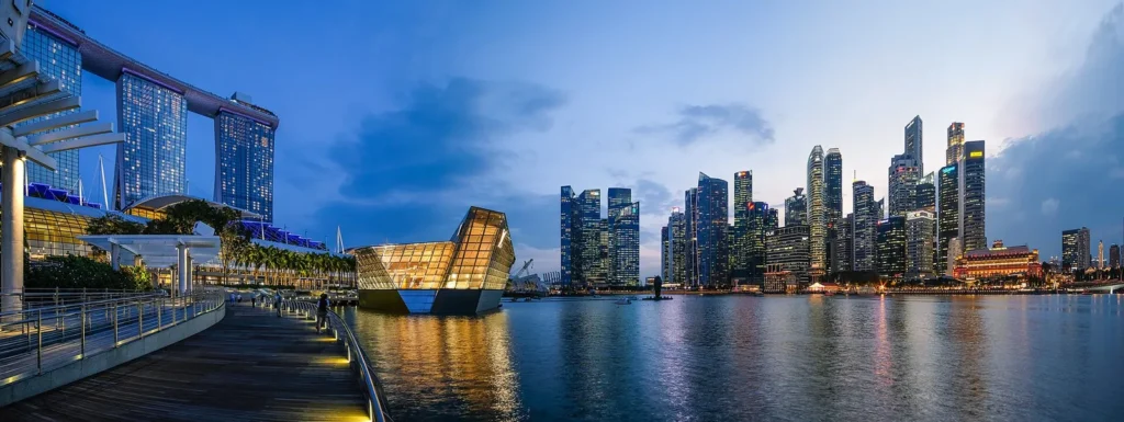 Marina Bay in Singapore at dusk with Marina Bay Sands and the city skyline lit up