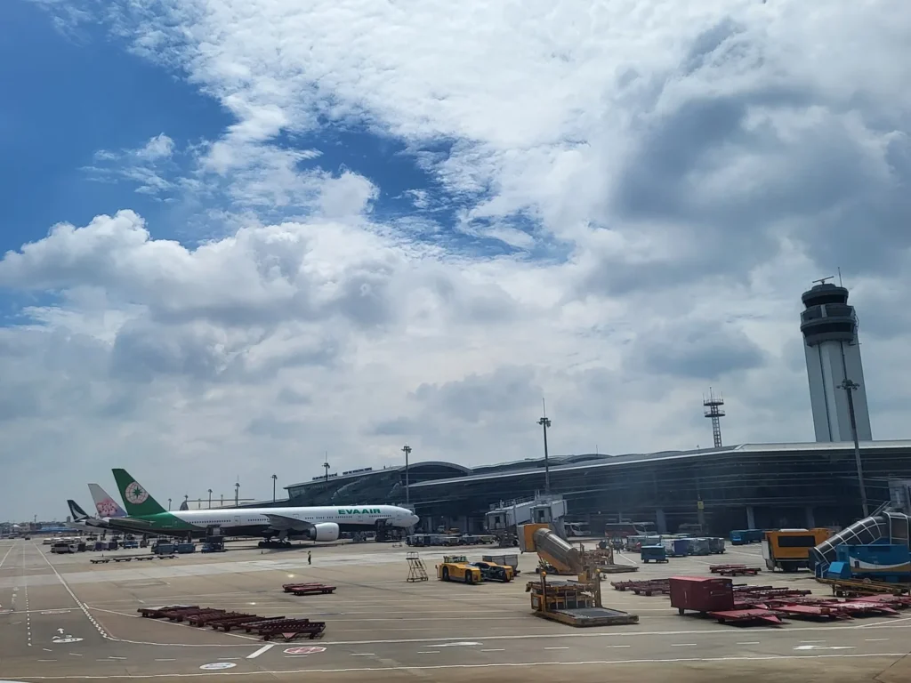 Aircraft parked at the international terminal of Tan Son Nhat Airport under a cloudy sky