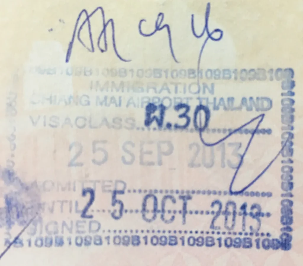 Thai immigration arrival stamp in a passport showing the visa class and permitted stay date