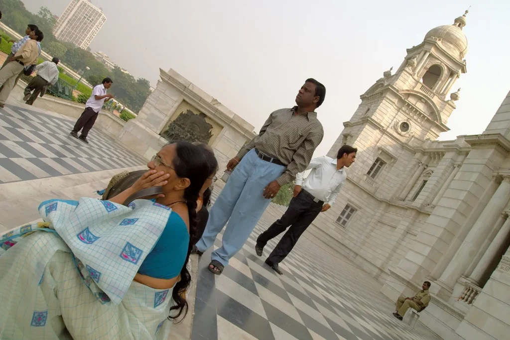 Visitors walking in the gardens in front of the Victoria Memorial